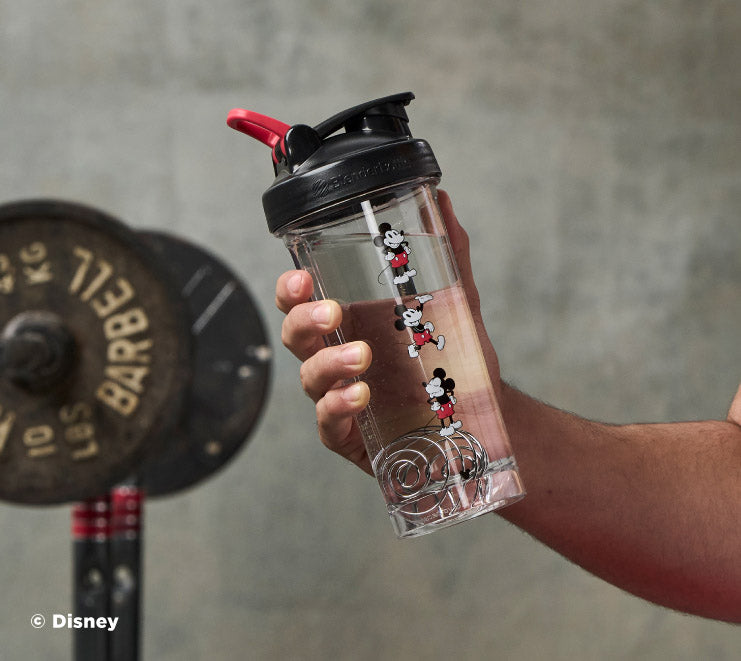 pro-series-k9 Mickey_Mouse_Protein_Shaker_Bottle_Being_Held_In_the_Gym.jpg